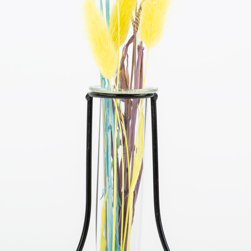 a metal framed, shaped outline of a vase that contains a glass test tube, in which to place flowers
