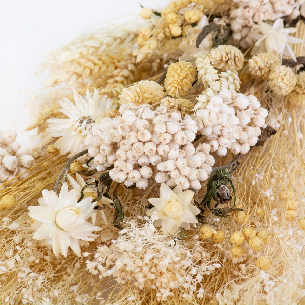 a bouquet made up with a selection of different flowers with an ecru theme