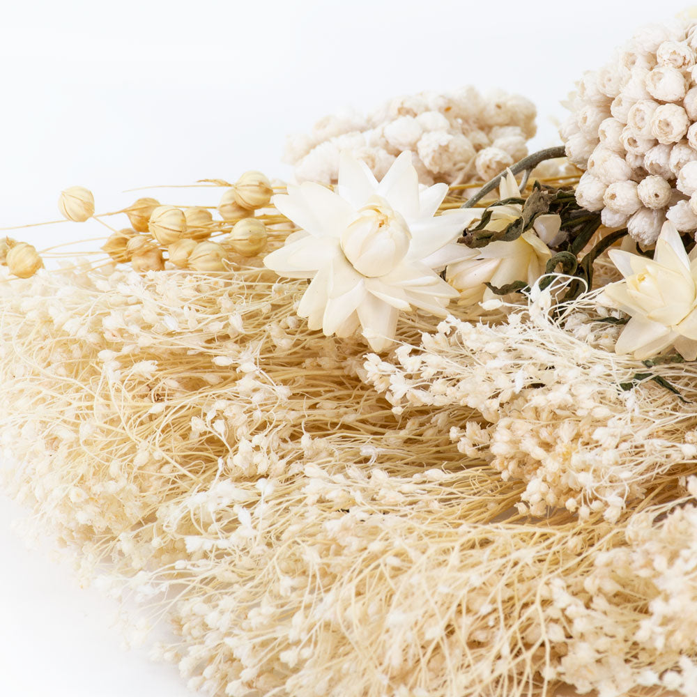 a bouquet made up with a selection of different flowers with an ecru theme