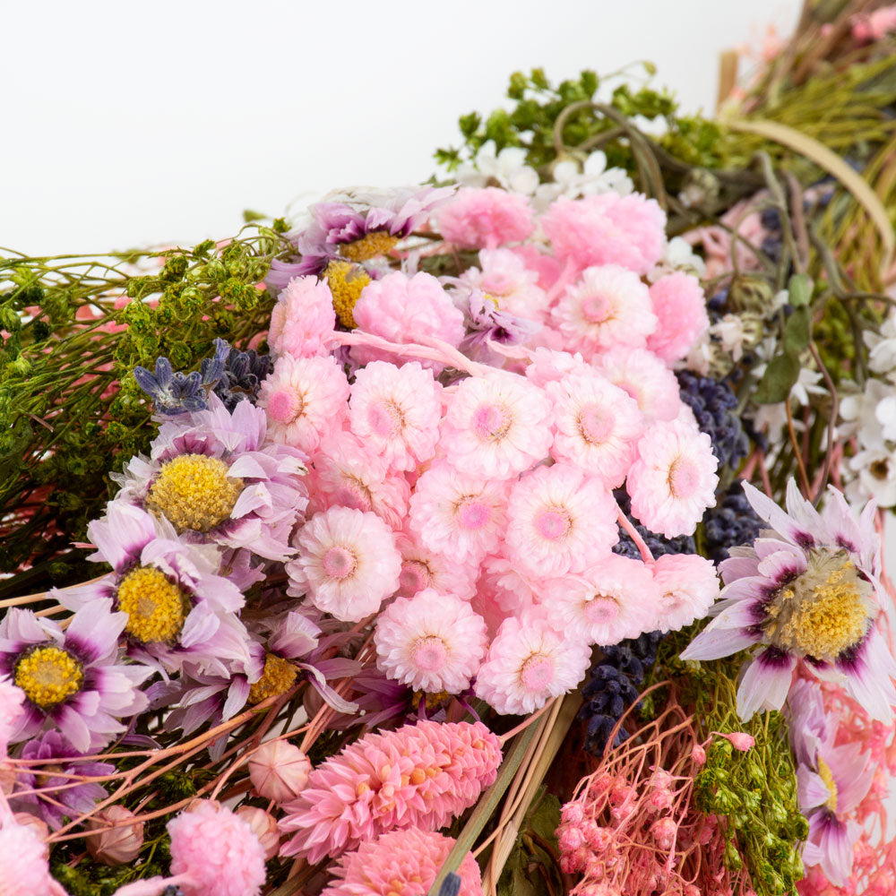 a bouquet made up with a selection of different flowers with a pink theme