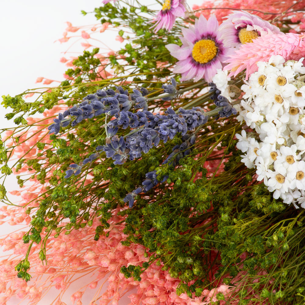 a bouquet made up with a selection of different flowers with a pink theme