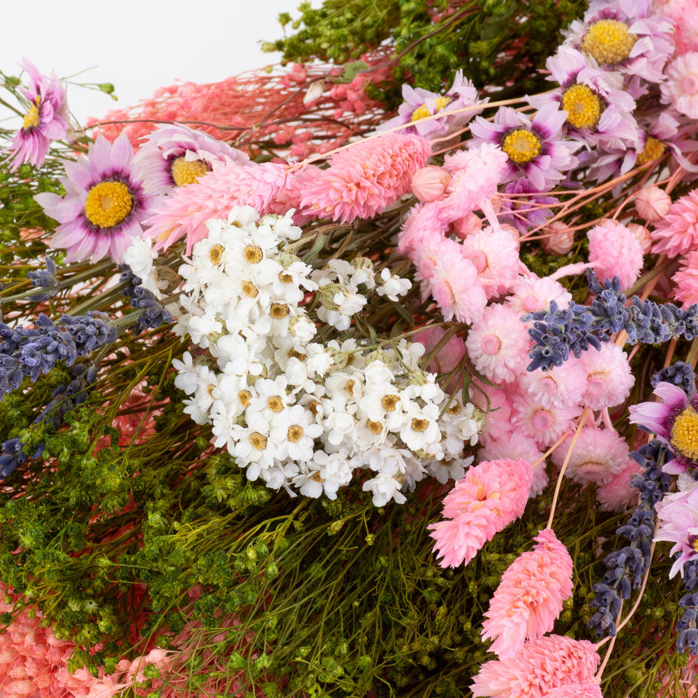 a bouquet made up with a selection of different flowers with a pink theme