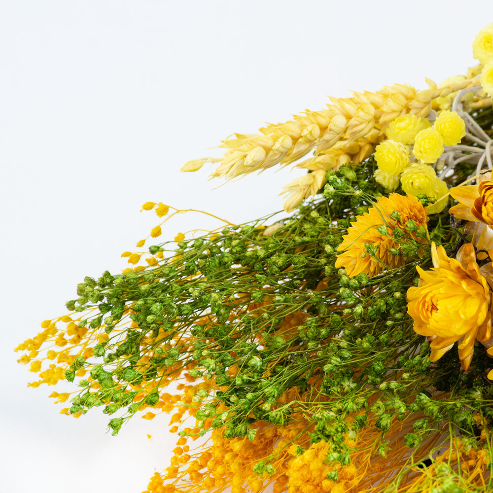 a bouquet made up with a selection of different flowers with a yellow theme