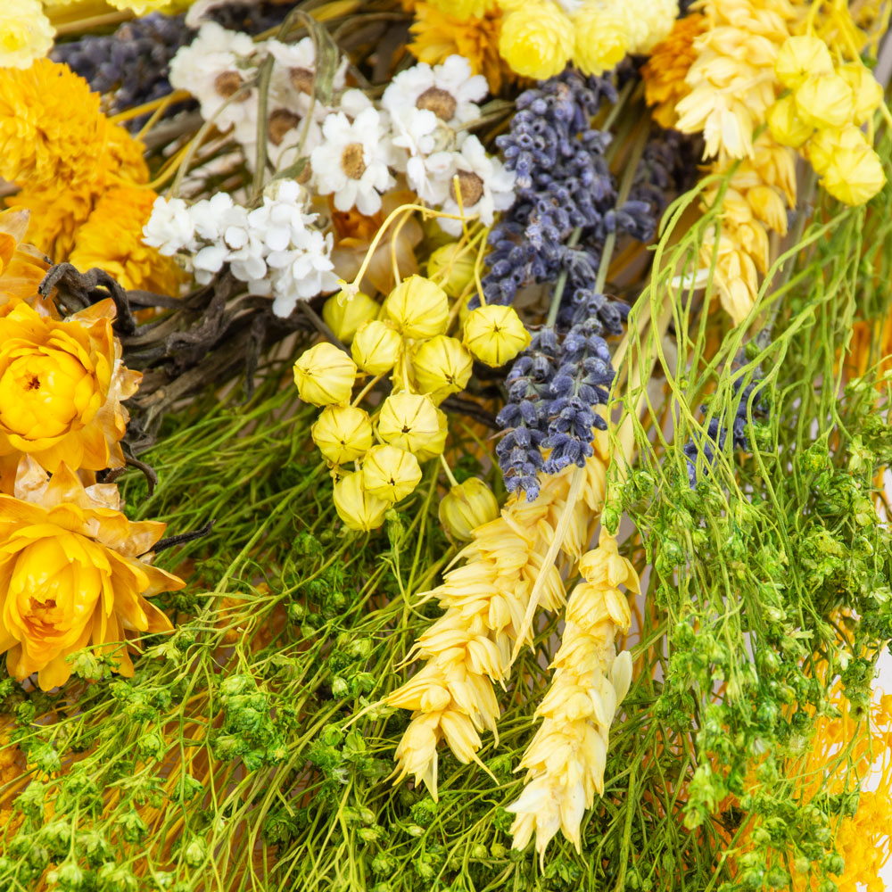 a bouquet made up with a selection of different flowers with a yellow theme