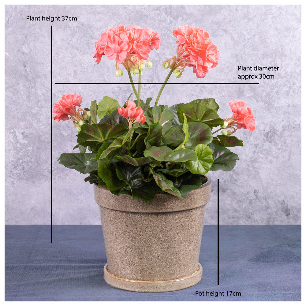 A faux, pink geranium plant displayed in a taupe coloured creamic pot.
