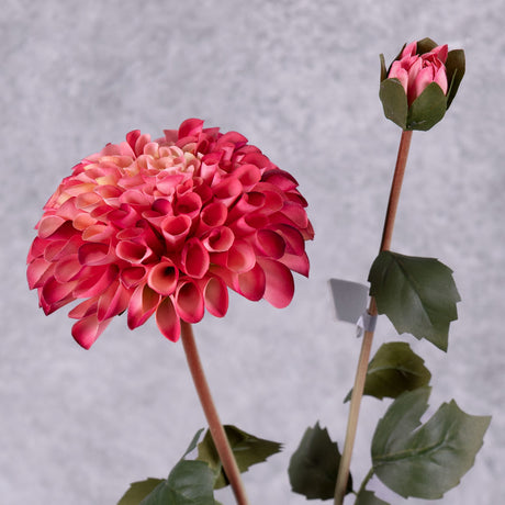 A close up of a faux deep pink dahlia spray showing a full bloom and emerging bud