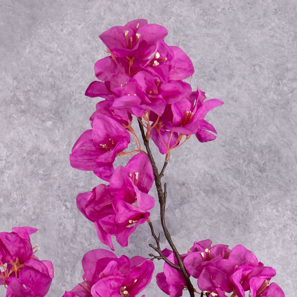 A close up of bright pink flowers on a faux Bougainvillea stem top