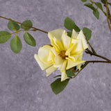 A close up of a faux yellow rose flower