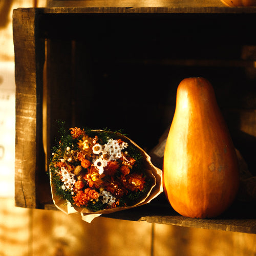A bunch of dried flowers and a gourd