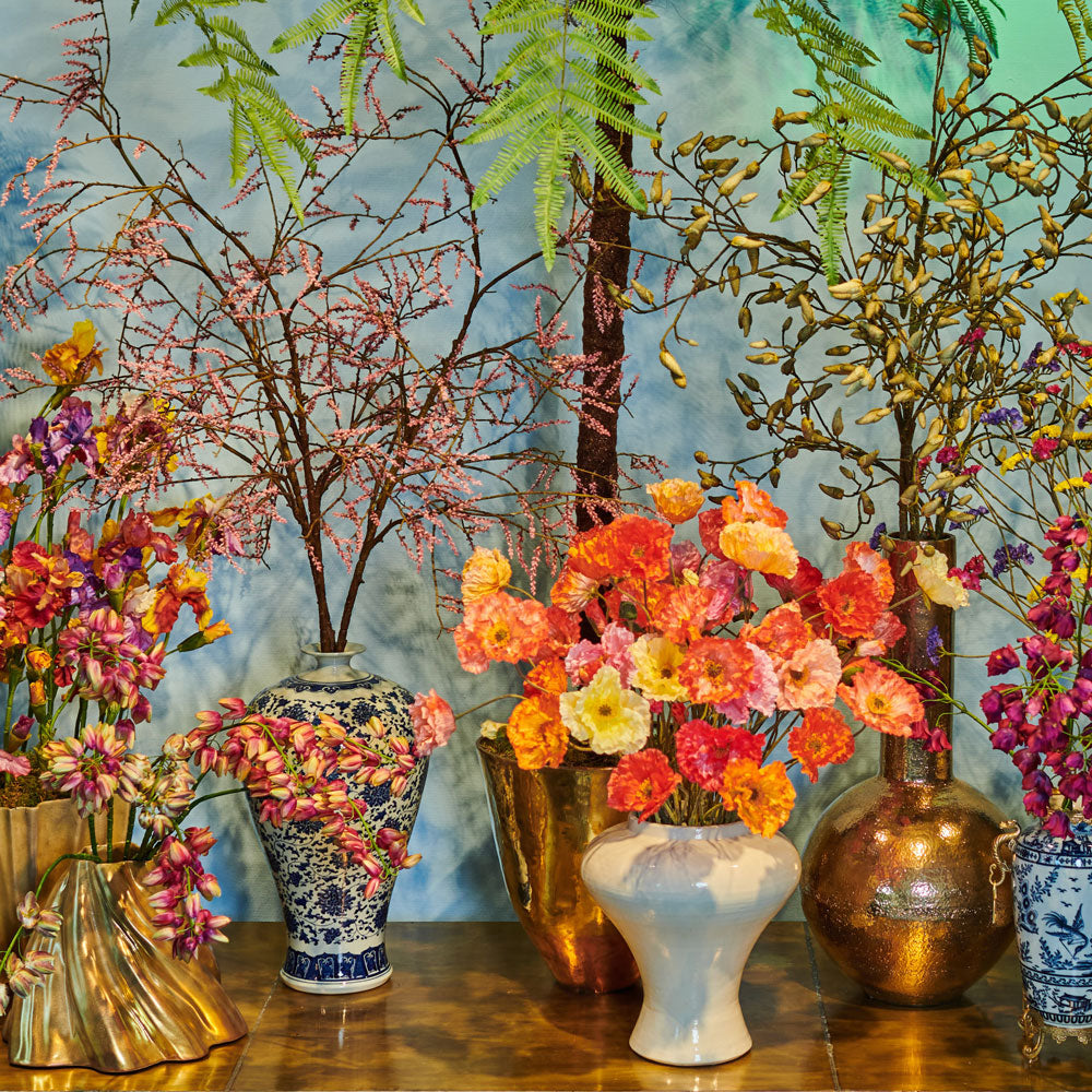 A table-top display of faux flower arrangements