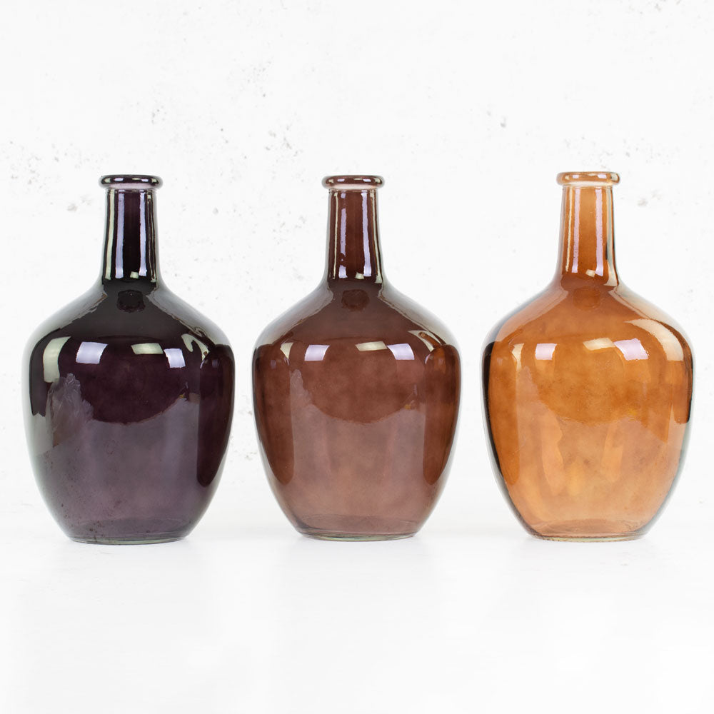 Trio of glass bottle vases in black, brown and coffee colour.