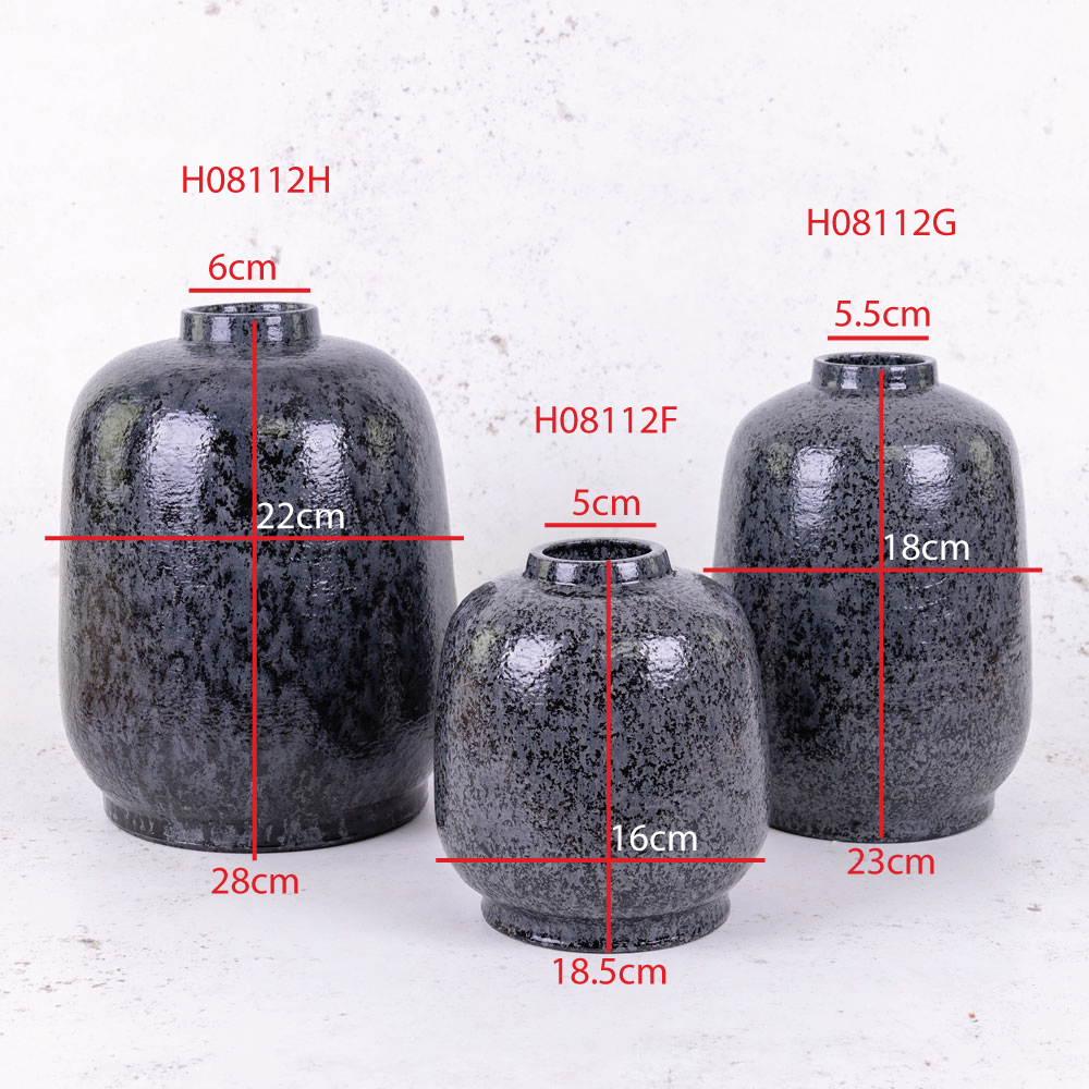 A group of black vases of different heights and widths