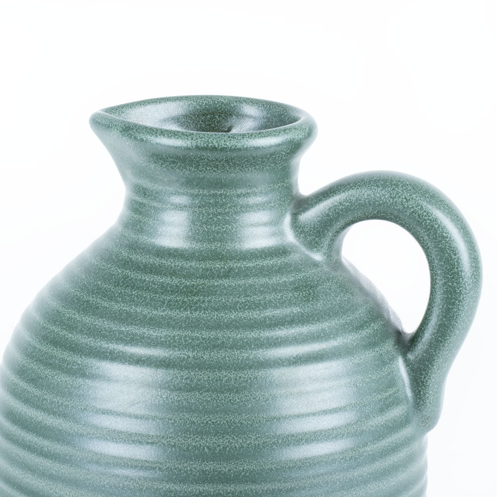 Our terracotta carafe looks stunning in a muted, old-green colour. It has a ridged pattern across the whole piece and a petite handle. 