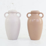 A pair of urn style vases in terracotta and white