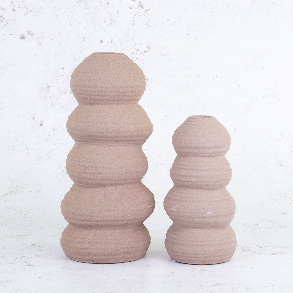 A comparison of terracotta balancing stone ceramic vases in different sizes
