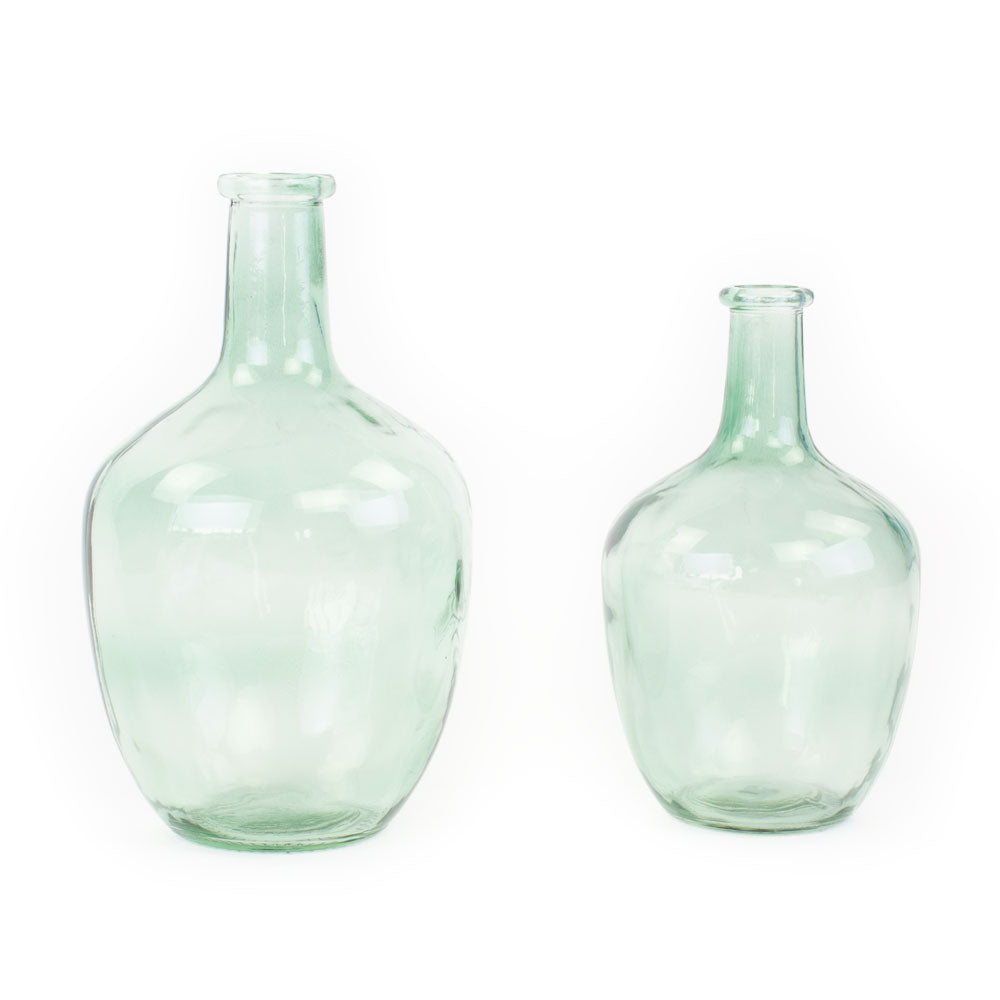 a pair of light green glass bottle vases