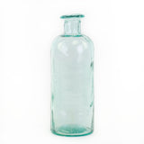 a blue/green glass bottle with an intentionally imperfect finish, showing air bubbles within the glass, and a slightly distorted finish