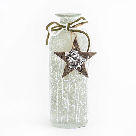 This image shows a pale green, frosted glass vase, with a small wooden star tied around its neck, against a white background