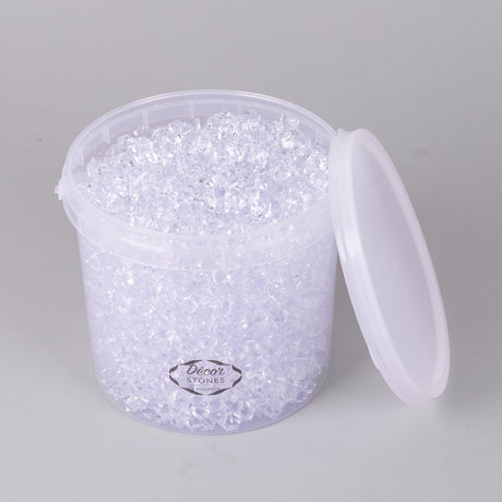 An open bucket of small, clear acrylic stones, in a plastic tub