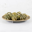 A group of scored, whole oranges in their un-ripened green colour/