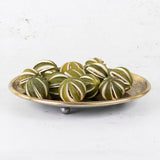 A group of scored, whole oranges in their un-ripened green colour/