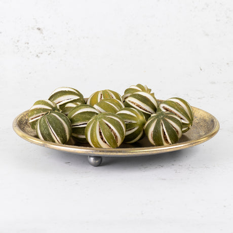 A group of scored, whole oranges in their un-ripened green colour/