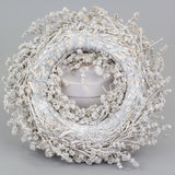a wreath made of linen herb and painted a chalky white colour, against a white background