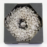 a wreath made of linen herb and painted a chalky white colour, against a white background