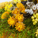 a bouquet made up with a selection of different flowers with a yellow theme
