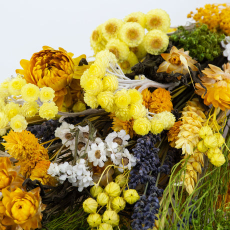 a bouquet made up with a selection of different flowers with a yellow theme