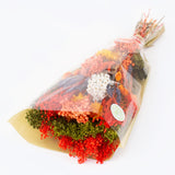 a bouquet made up with a selection of different flowers with an orange theme