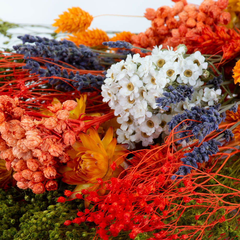 a bouquet made up with a selection of different flowers with an orange theme