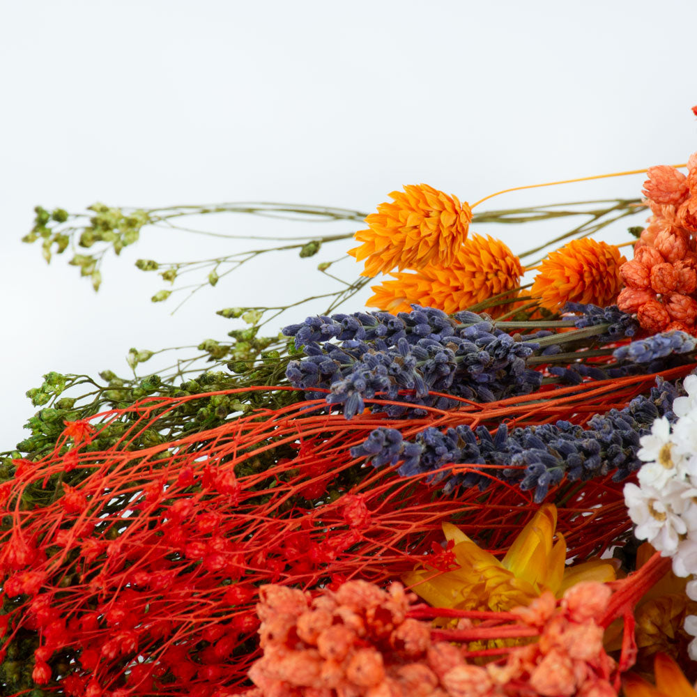 a bouquet made up with a selection of different flowers with an orange theme