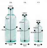 a group of three Waimaru blue/green glass bottles in different sizes