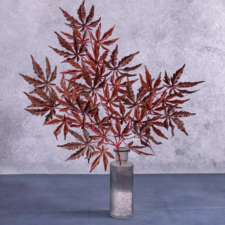 An artificial Japanese Acer, in rich Burgundy, displayed in a decorative glass vase