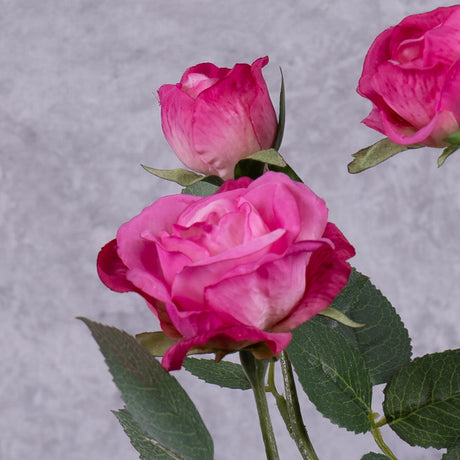 The close up of a faux dark pink rose