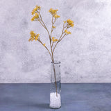 An artificial Dogwood (Cornus) Bud Branch Green 70cm long in a clear glass vase