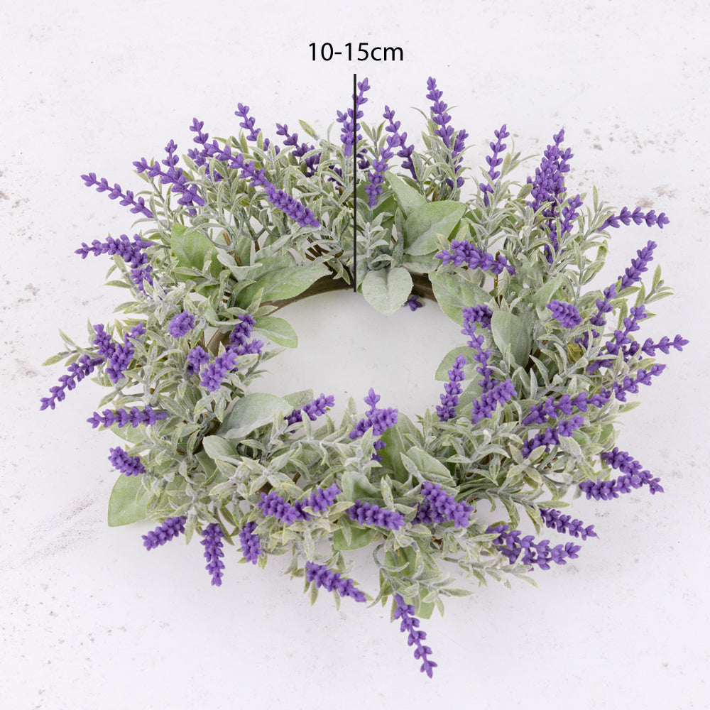 An artificial floral wreath made up of lavender flowers and silvery-green leafy foliage