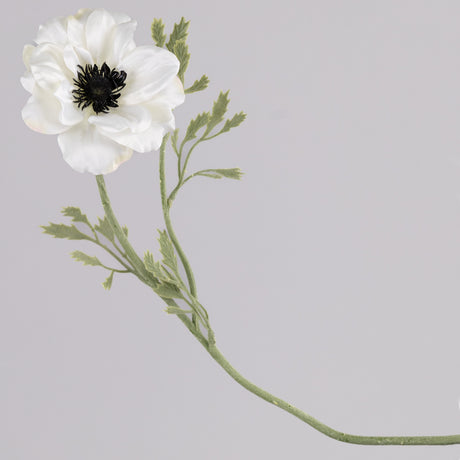 A faux anemone flower and stem with leaf detail, in white.