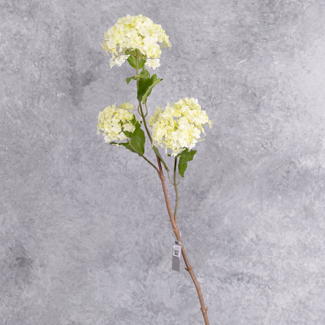 A faux viburnum spray heads in a cream colour with green tinges