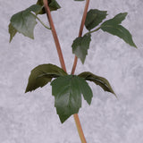 A close up of the foliage on a faux dahlia spray