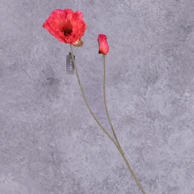A faux poppy spray, with flowers in an acid pink colour