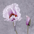 A faux poppy stem with an open flower and a budding flower on two branchlets. The flowers are a pale lavender colour that gets darker toward the centre of the flower