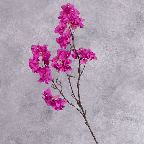 A faux Bougainvillea stem with bright pink flowers over several branchlets