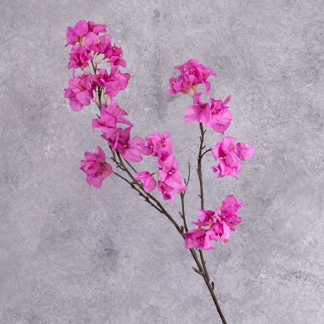 A faux Bougainvillea spray with bright pink flowers over multiple branchlets