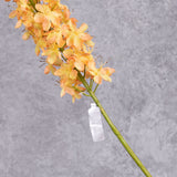 A close up of a faux peachy-yellow eremurus flower