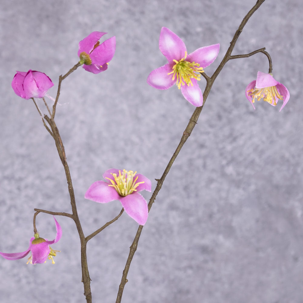 A close up of a faux thalictrum spray covered in strong pink flowers