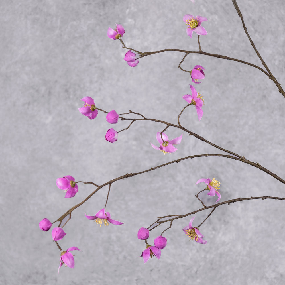 A close up of a faux thalictrum spray covered in strong pink flowers