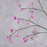 A close up of a faux thalictrum spray covered in strong pink flowers