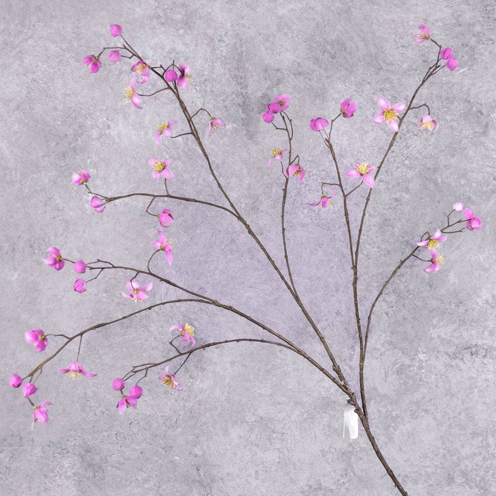 A faux thalictrum spray covered in strong pink flowers over many branchlets